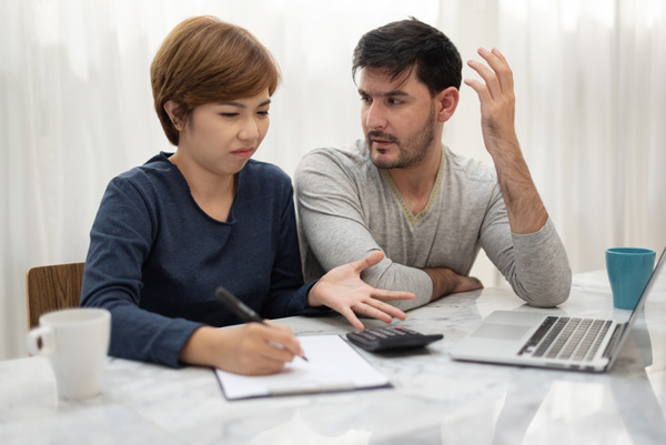 couple calculating costs of moving across the country